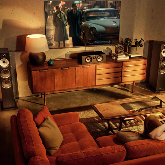 Living room with red sofa, wooden sideboard, and vintage car shown on tv.