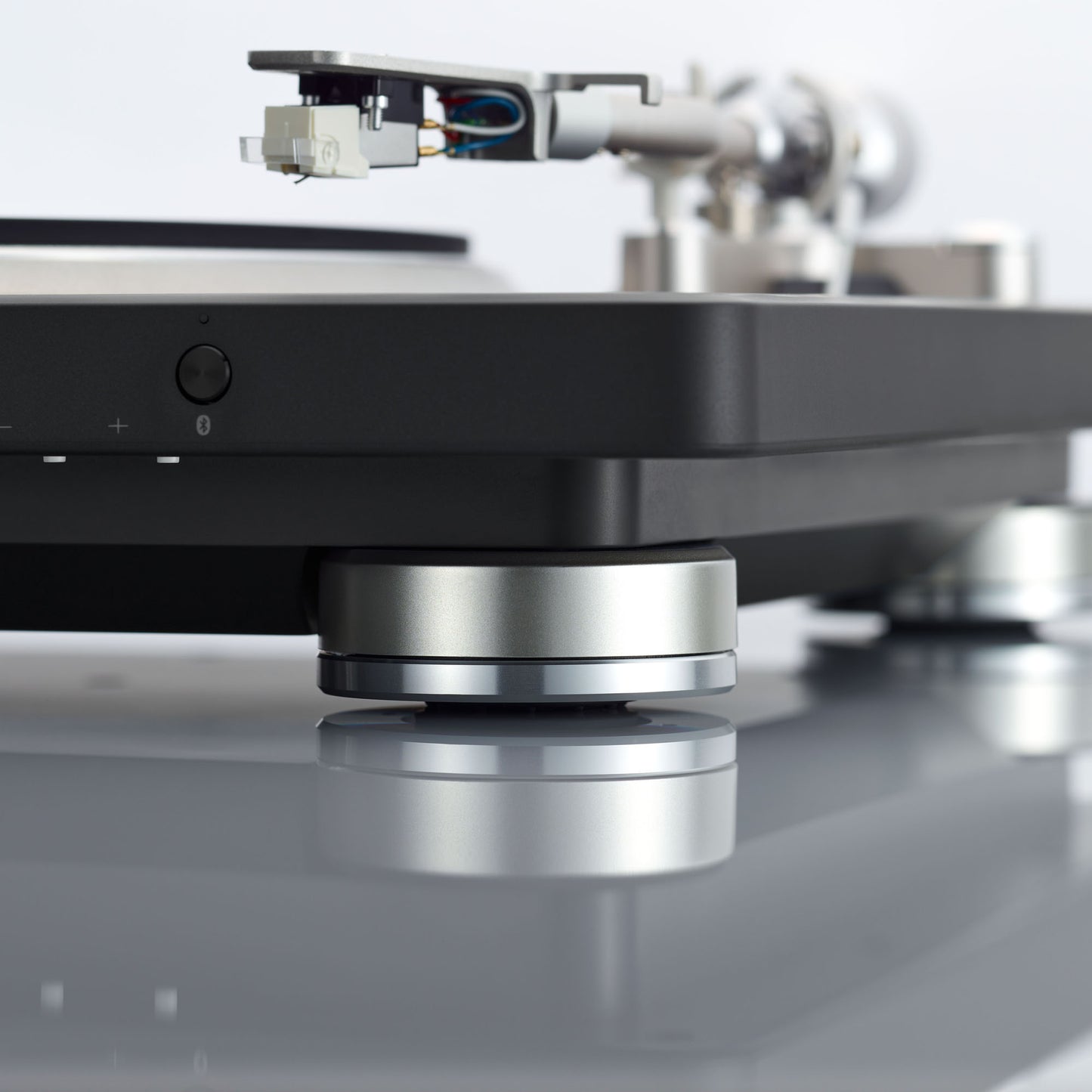 Close-up of a turntable with a needle on a white background