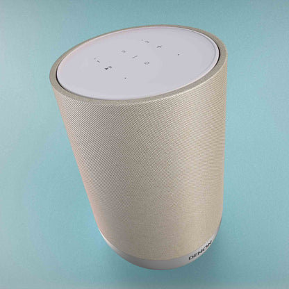 Denon Home 200 speaker with control panel on a light blue background