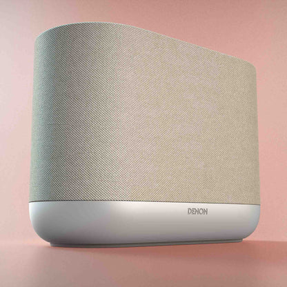 Denon Home 400 Speaker in white with 'Denon' branding on a pink background