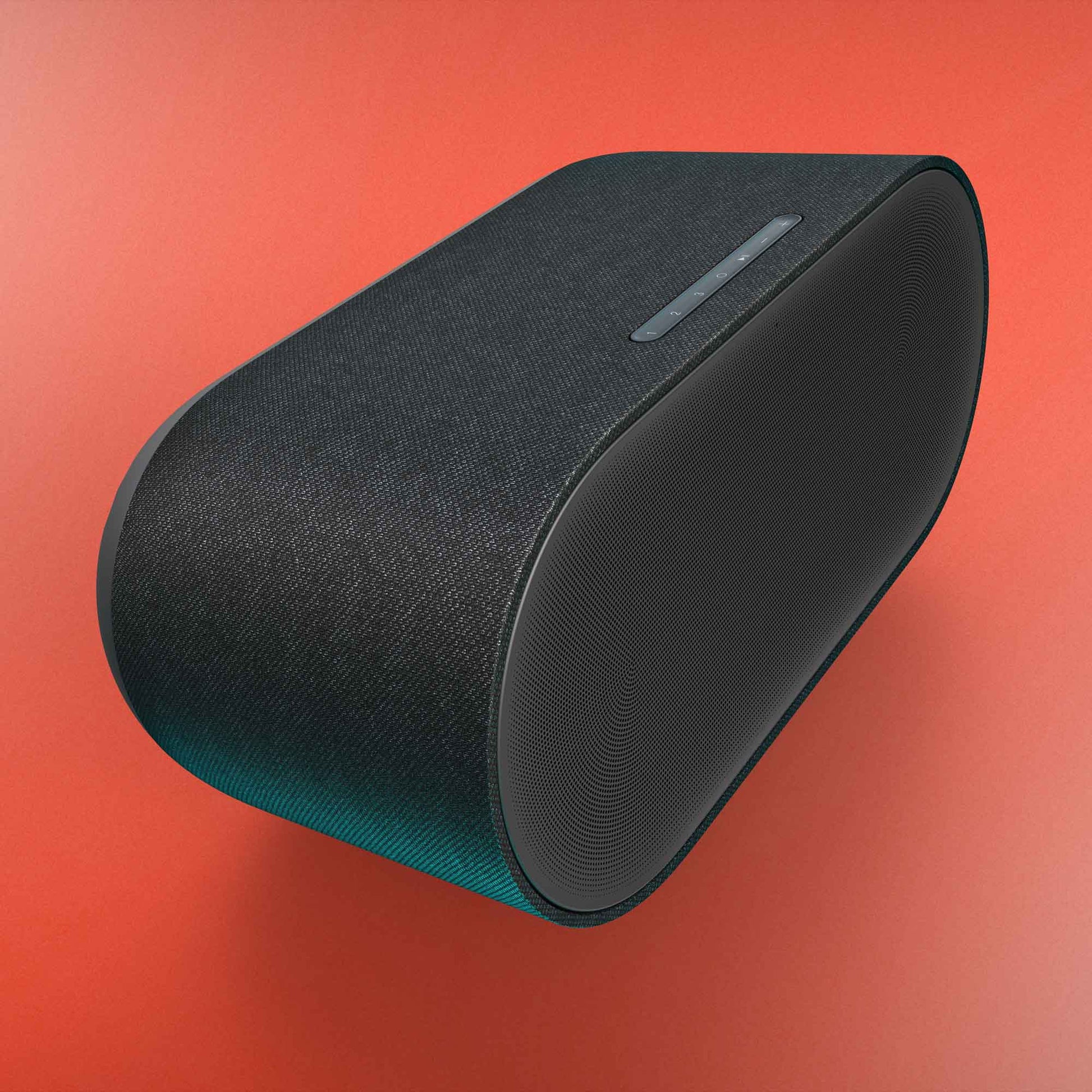 Black Denon Home 600 Wireless Speaker on orange background