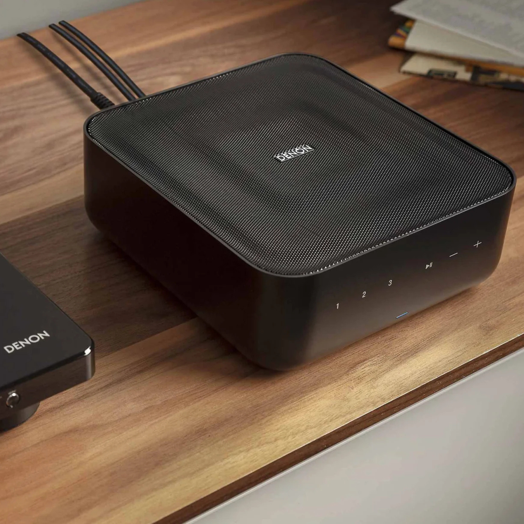 Lifestyle view of Denon Home Amp on timber shelf