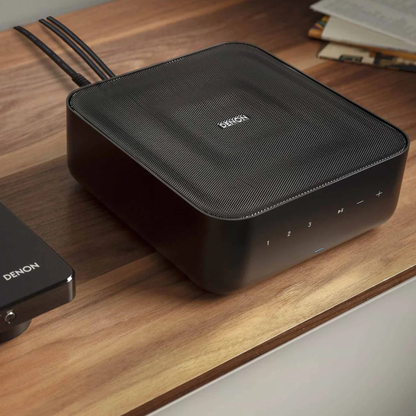 Lifestyle view of Denon Home Amp on timber shelf