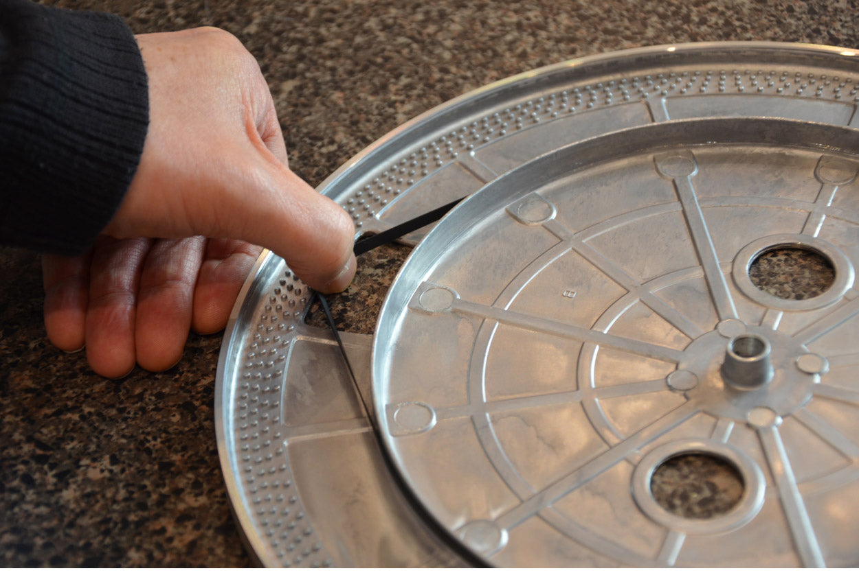 Step 4 - Install the new belt around the outside of the inner rim. You should be able to easily pull it away to refit around the motor spindle.