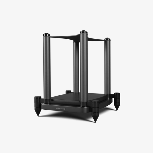 A black metal speaker stand with four vertical legs, a top support bar, and pointed feet, shown on a light gray background.
