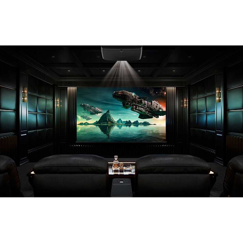 Home theater setup with a large screen, surrounded by dark walls and seating.