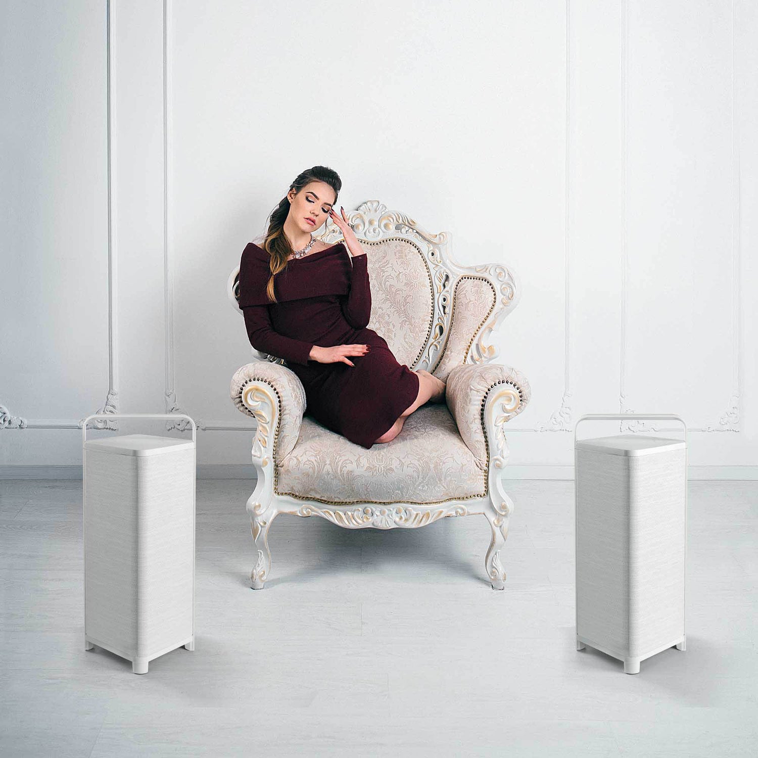 2 Escape Bluetooth Speakers in white room with lady sitting on a chair