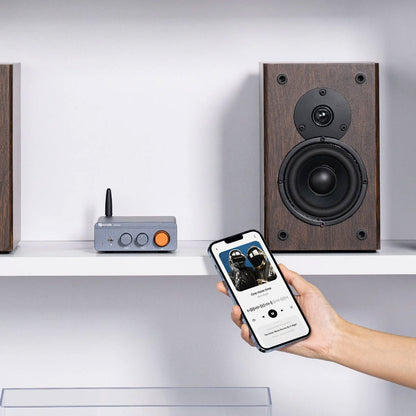 Wooden speakers on a shelf with a smartphone and Fosi Audio BT20A Pro, against a white background