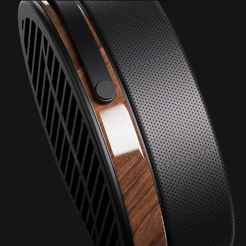 Close-up of a high-end headphone with wooden and metallic accents on a black background