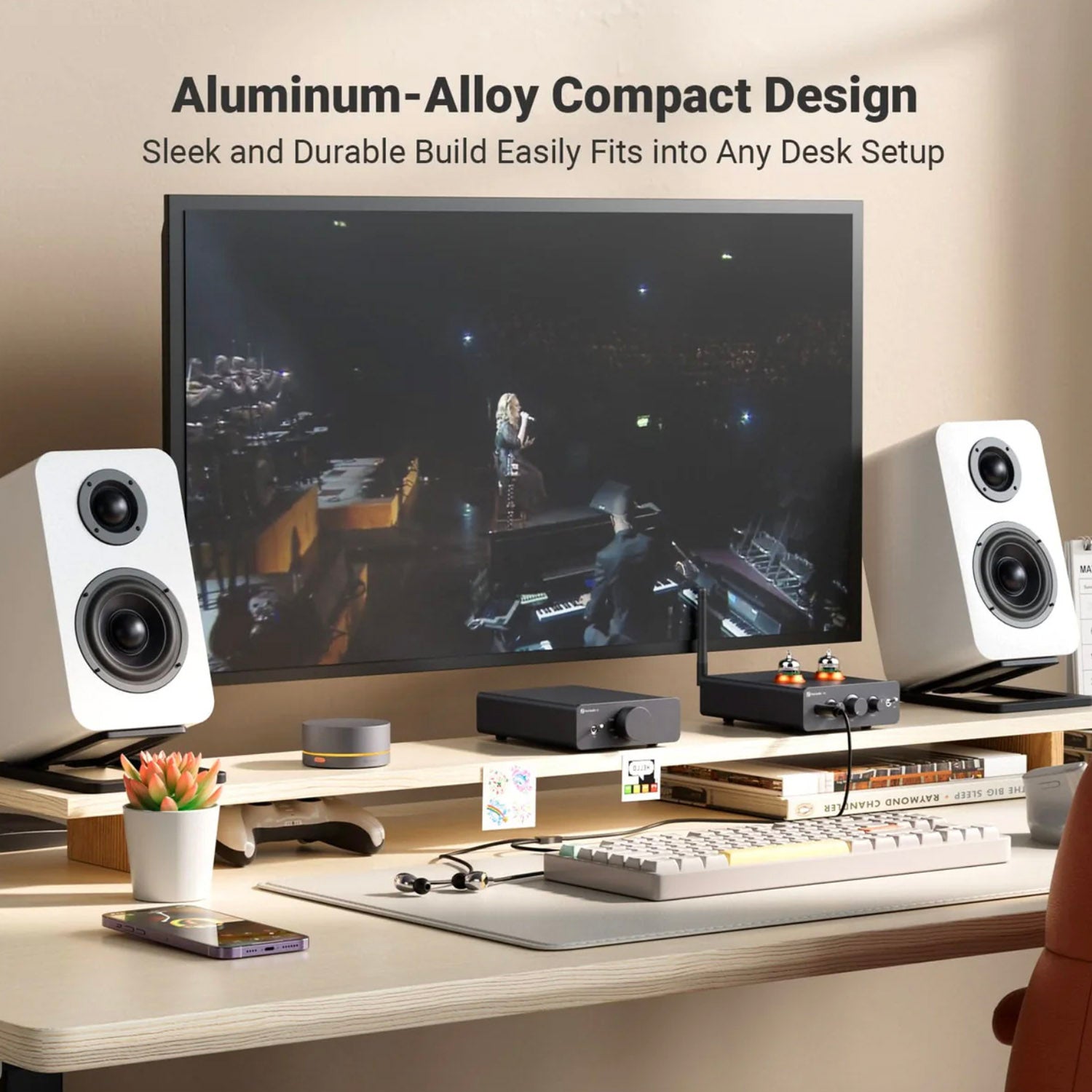 Modern desk setup with computer monitor, speakers, and keyboard on a neutral background