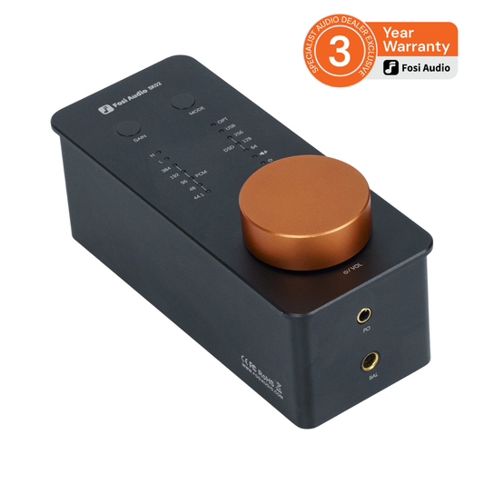 Fosi Audio S1100 Class-D amplifier in matte black with a prominent copper-coloured rotary volume knob, shown on a white background with a promotional warranty badge in the top right corner.