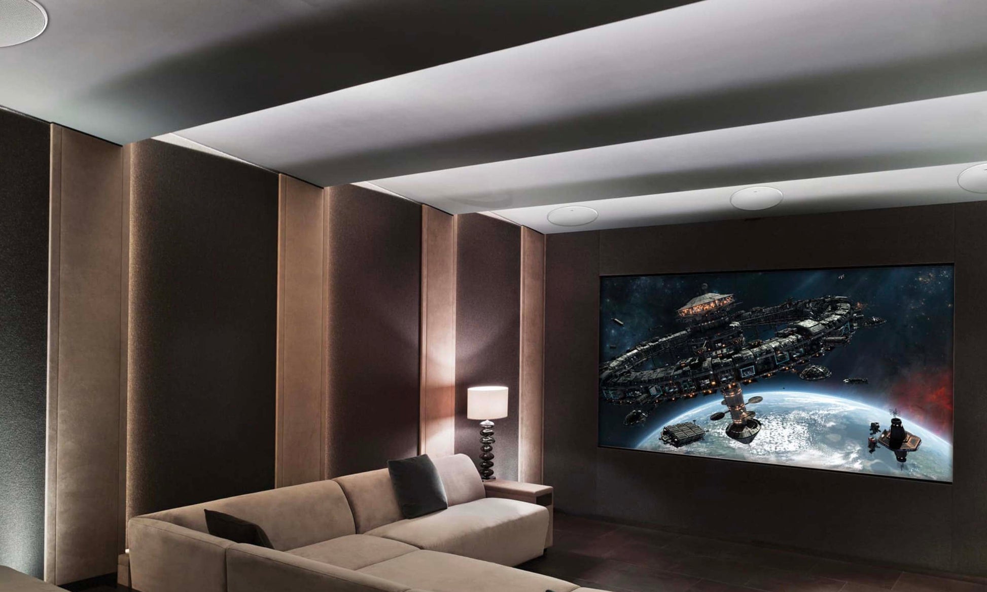 Modern cinema room with a large TV displaying a space-themed movie