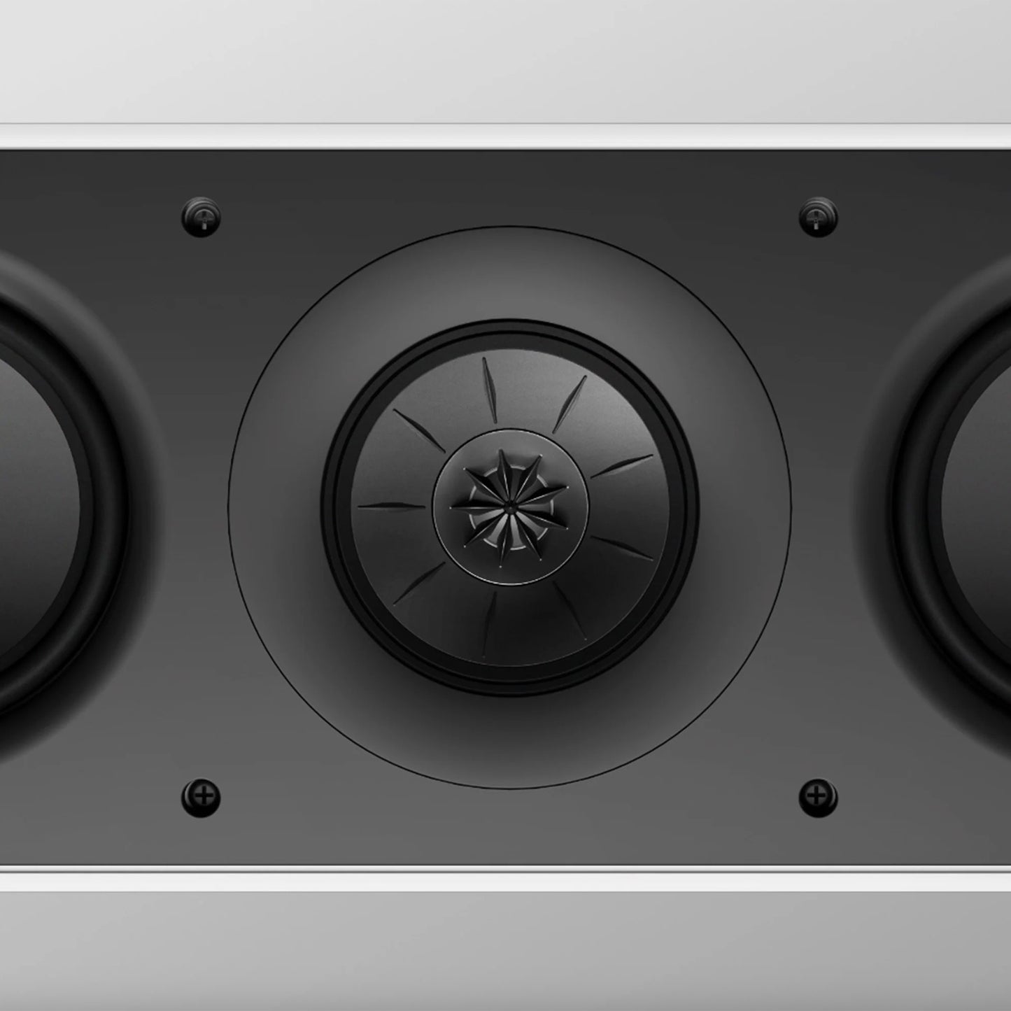 Close-up of a KEF speaker with a metallic finish on a grey background