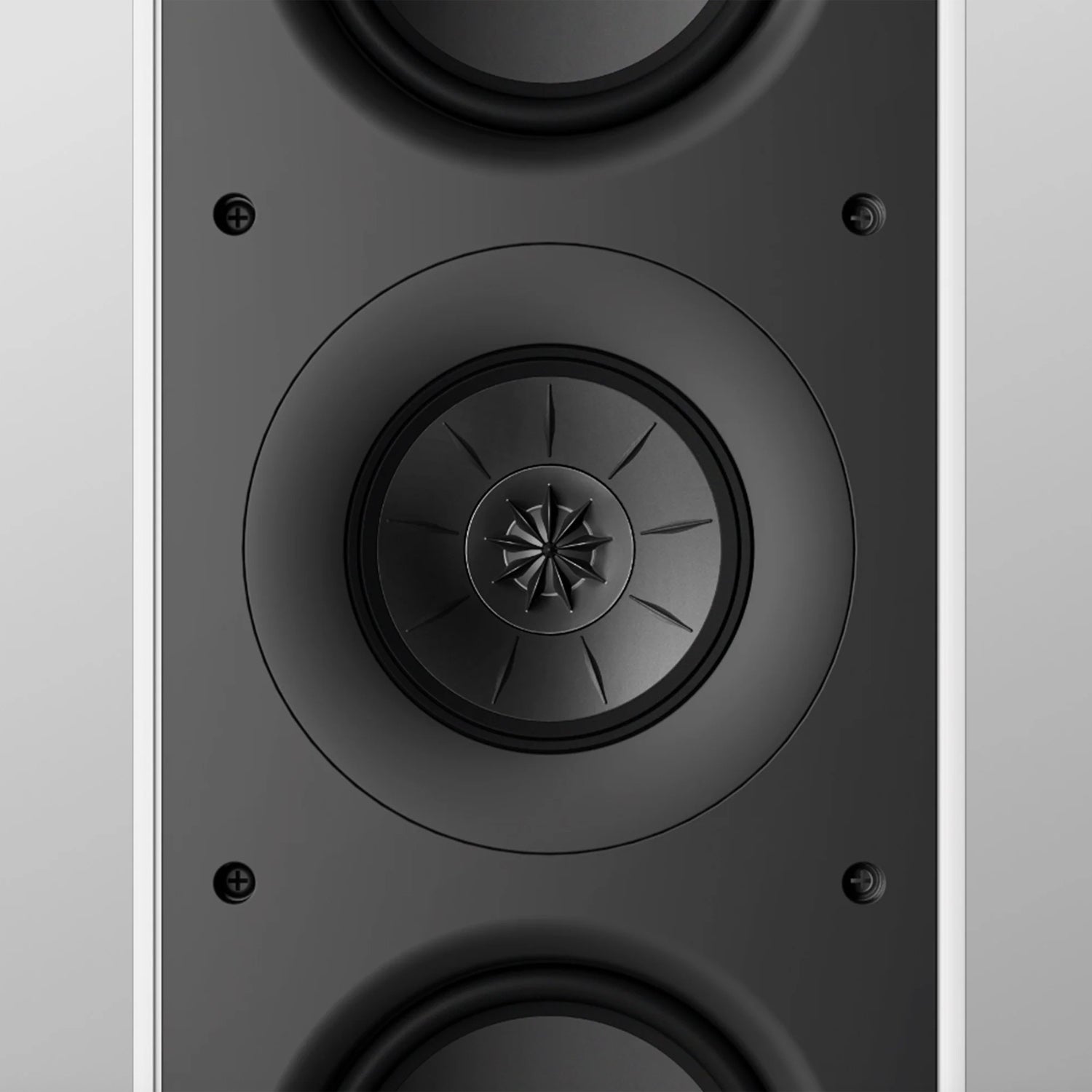 Close-up of a KEF speaker on a grey background