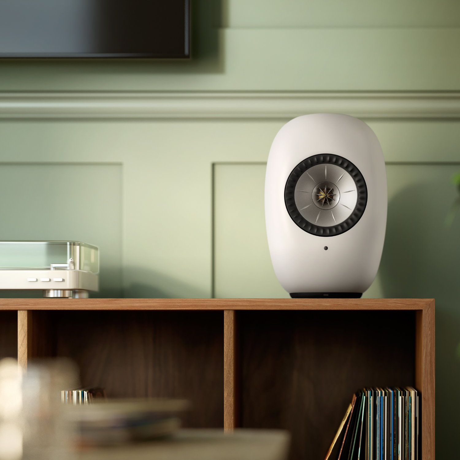 KEF LS LUXE Wireless Powered Speaker in Mineral White finish on shelf with light green wall behind