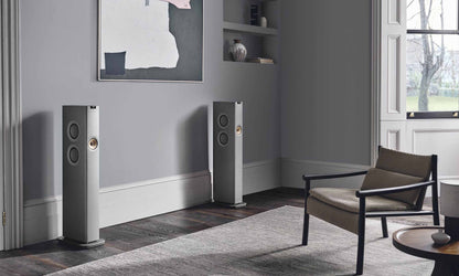 KEF LS60 Wireless Streaming System in living room with picture on the wall and chair