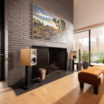 Klipsch The Nines II Powered Speakers in red oak in living room against grey brick wall