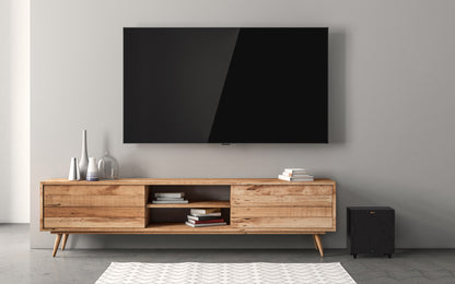 Wooden TV stand with a large flat-screen TV mounted on a gray wall.