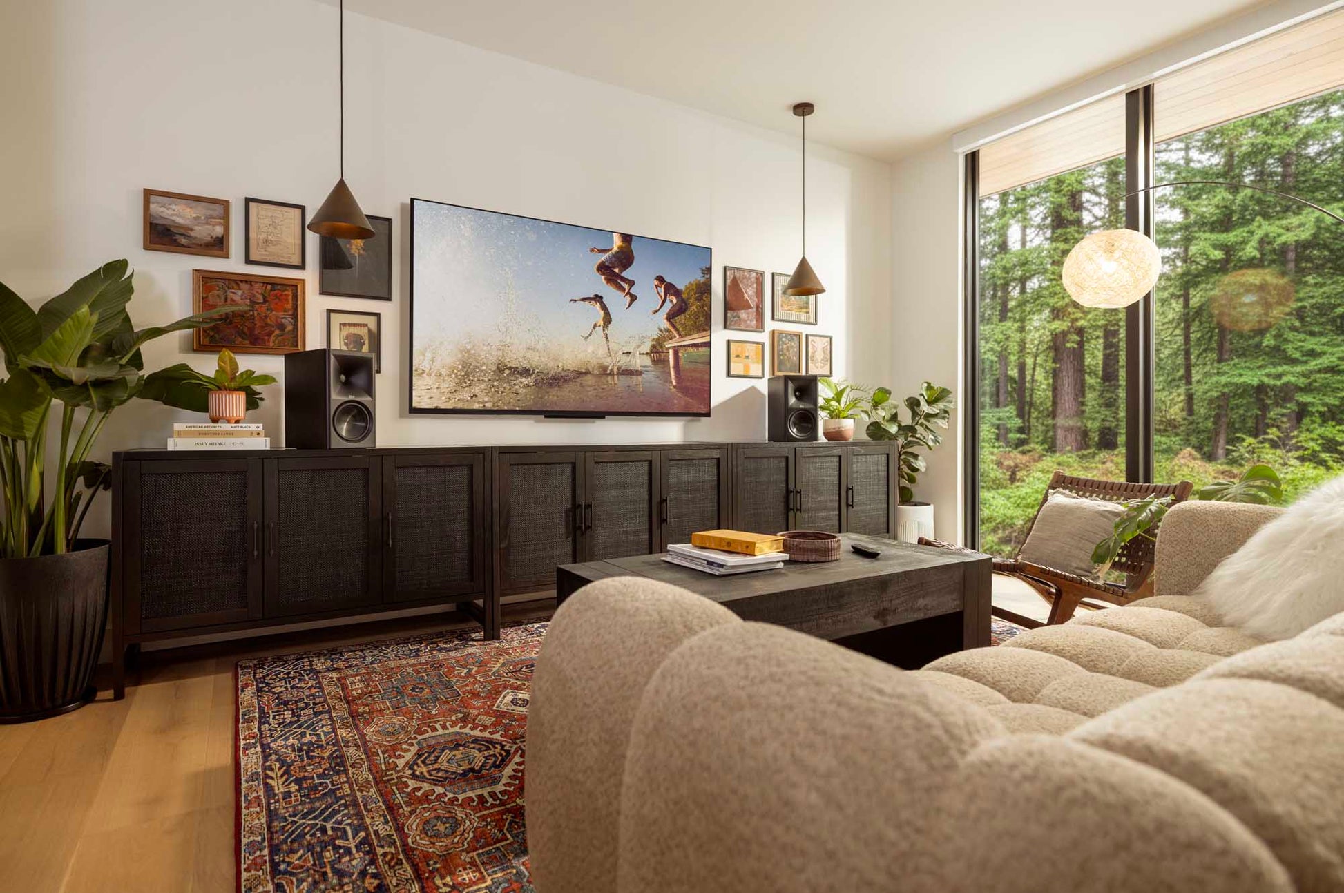 Living room with a large TV, sofa, and decorative elements.