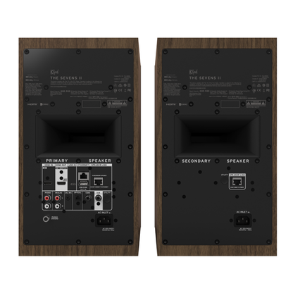Back view of walnut Klipsch The Sevens II Powered Speakers on white background