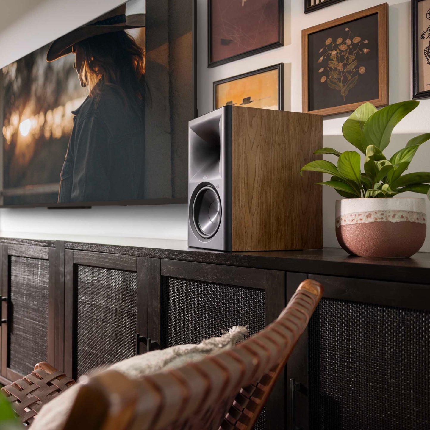 Klipsch The Sevens II Powered Speakers sitting on timber cabinet next to pot plant