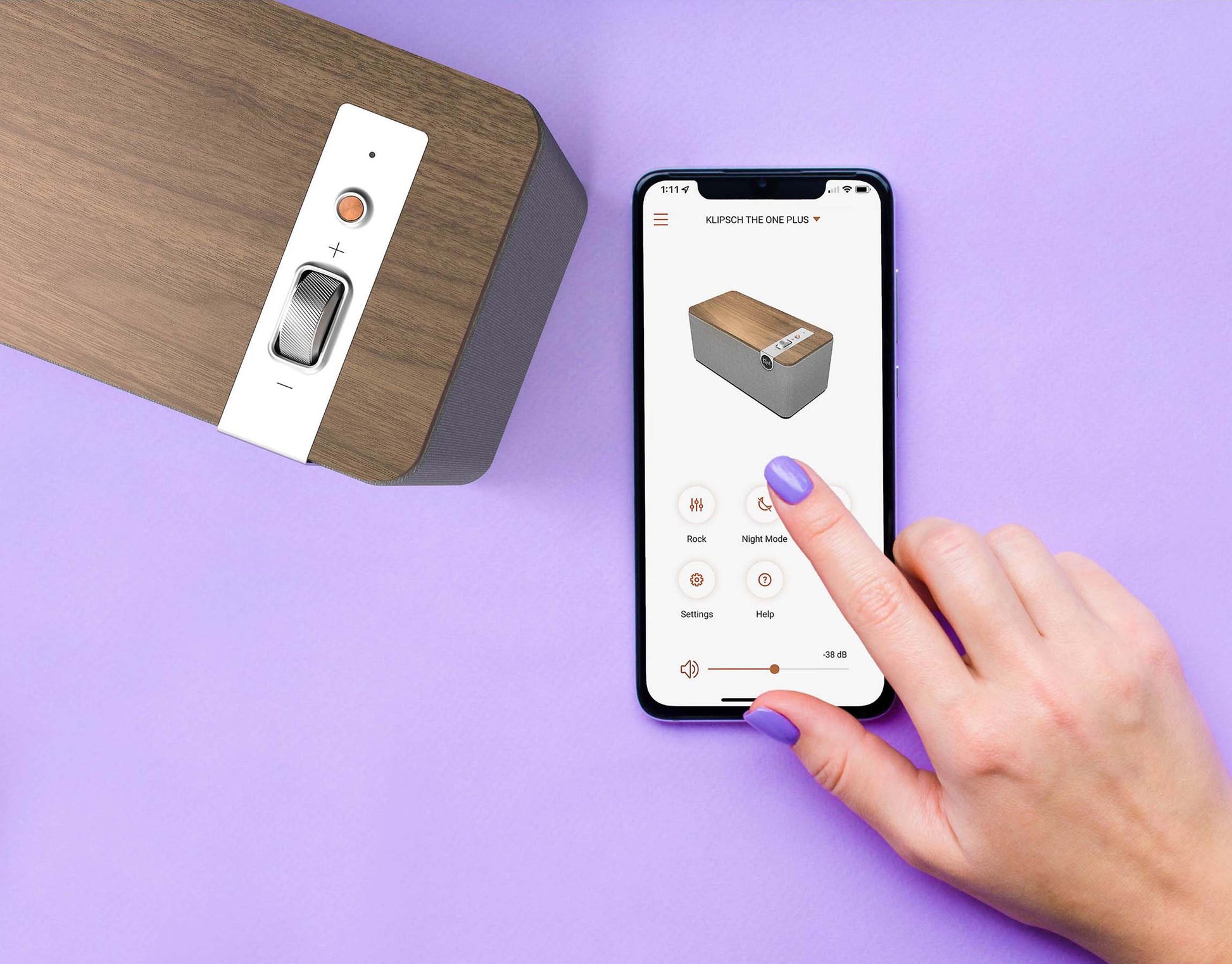 Hand using a smartphone app to control a klipsch speaker on a purple background
