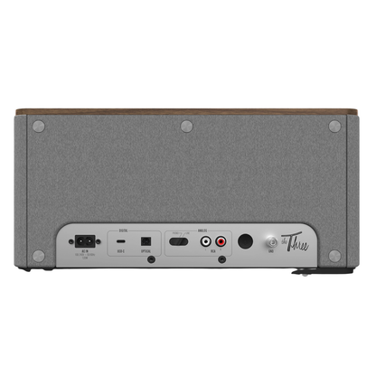 Back view of Klipsch The Three Plus Bluetooth Speaker in walnut on white background
