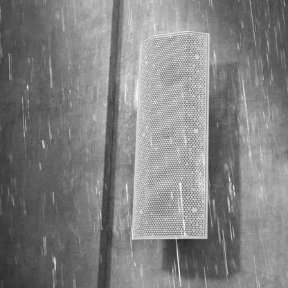 Lithe Audio IO1 Indoor Outdoor Passive Speaker on grey wall in the rain