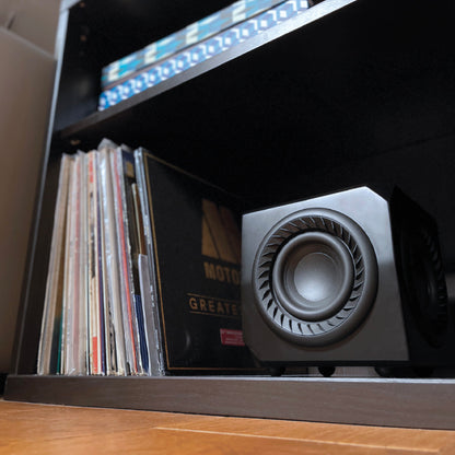 Lithe Audio Wireless Micro Subwoofer on shelf with records