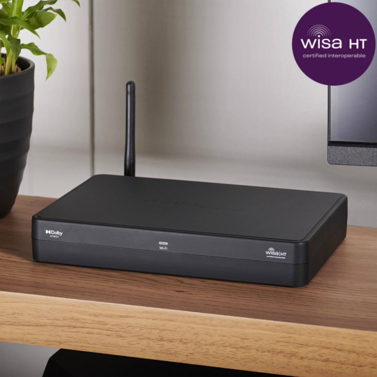 Black router on a wooden surface with WISa HT certification badge in the corner.