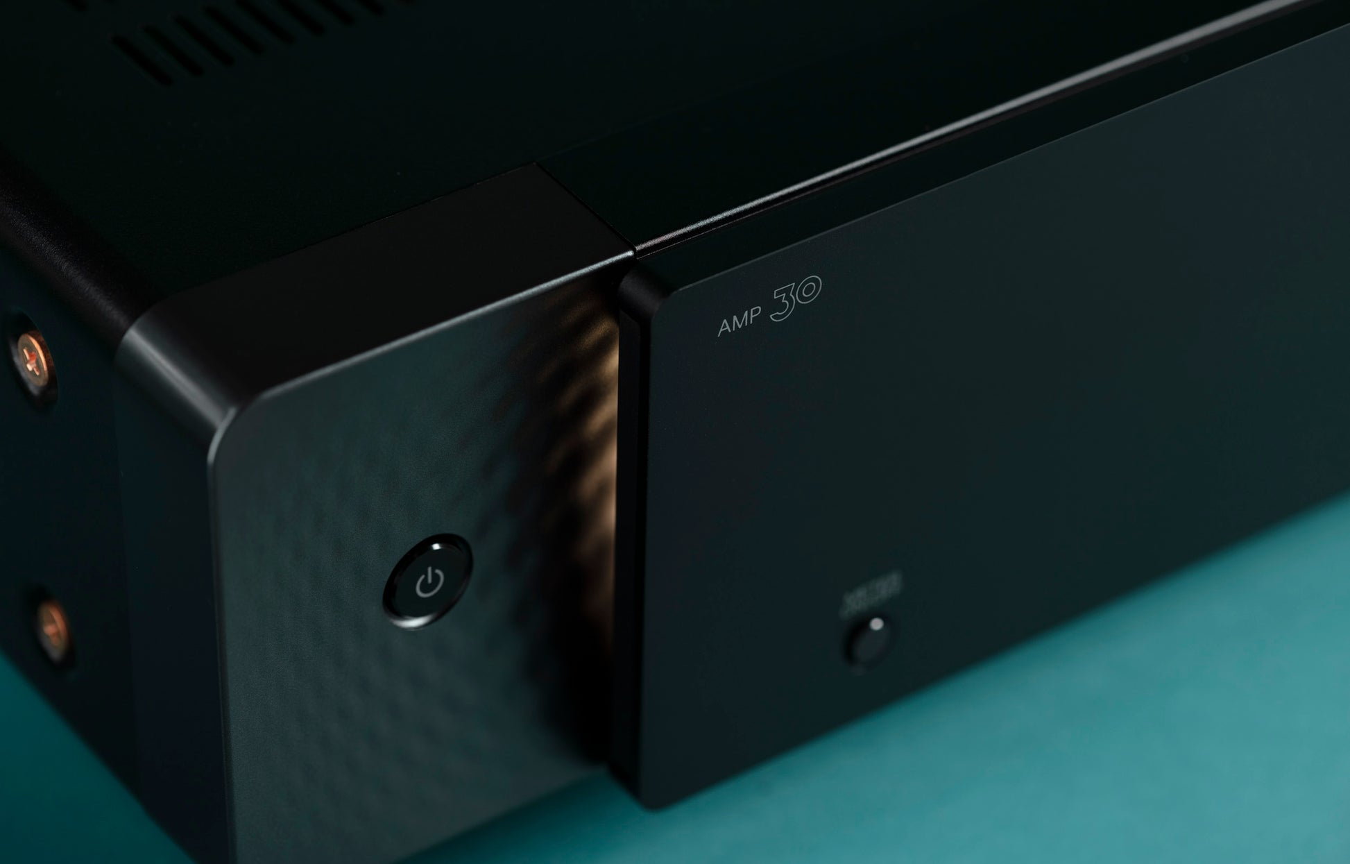 Close up view of Marantz AMP 30 on teal background