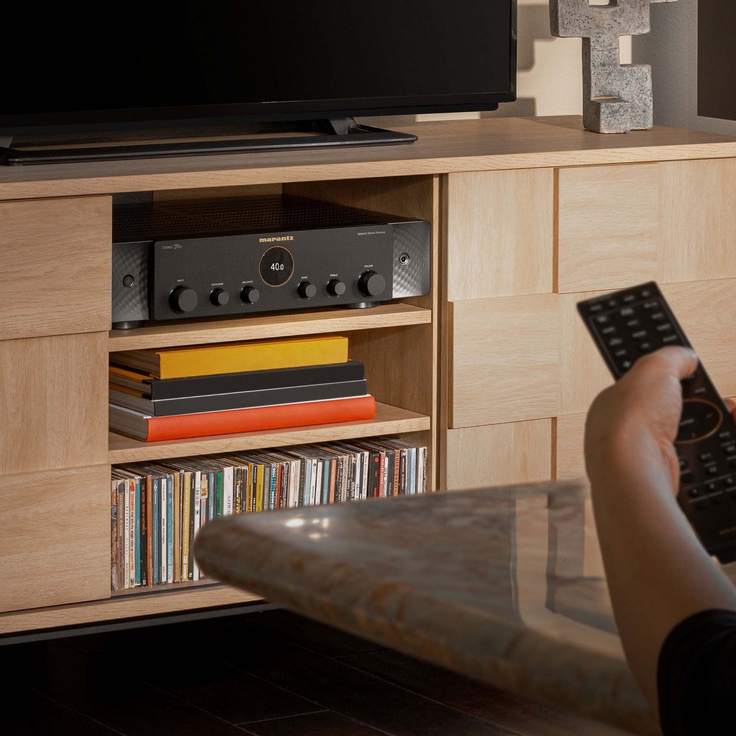 Marantz in cabinet and an arm using a remote