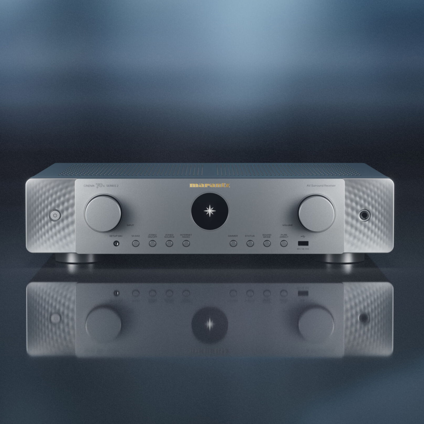 A silver Marantz Cinema 70s Series 2 AV Receiver on a blue grey gradient background
