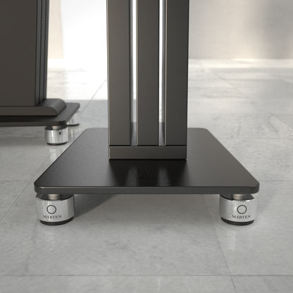 Black metal stand with silver Marten Isolators on a tiled floor