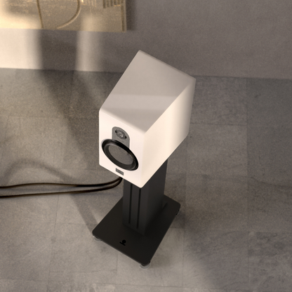 White speaker on a black stand against a gray tiled wall