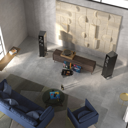 Modern living room with blue sofa, coffee table, and decorative wall art.