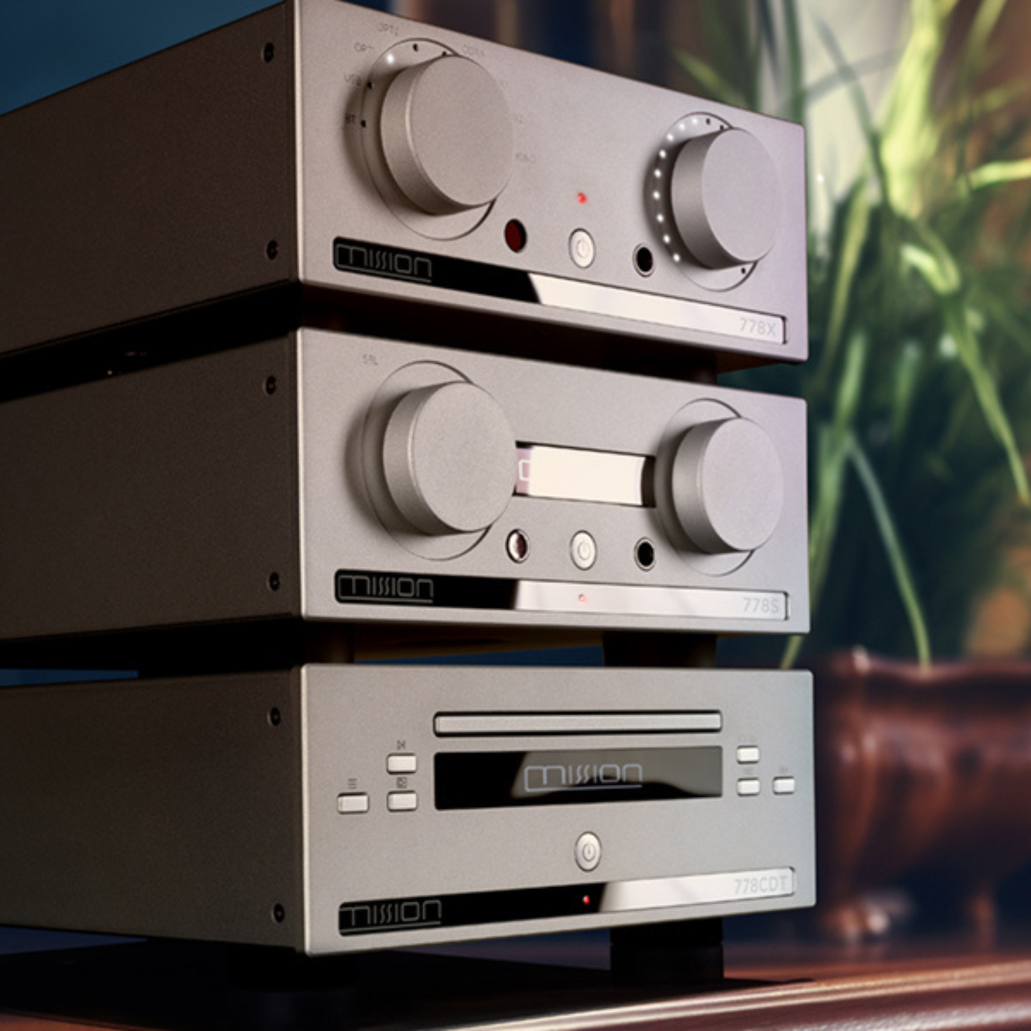 Stack of audio components with 'Mission' branding on a blurred background