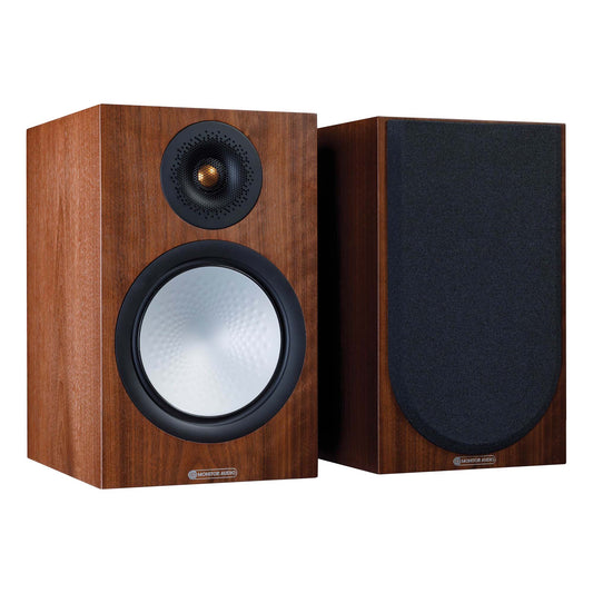 Pair of wooden speakers with black grills on a white background
