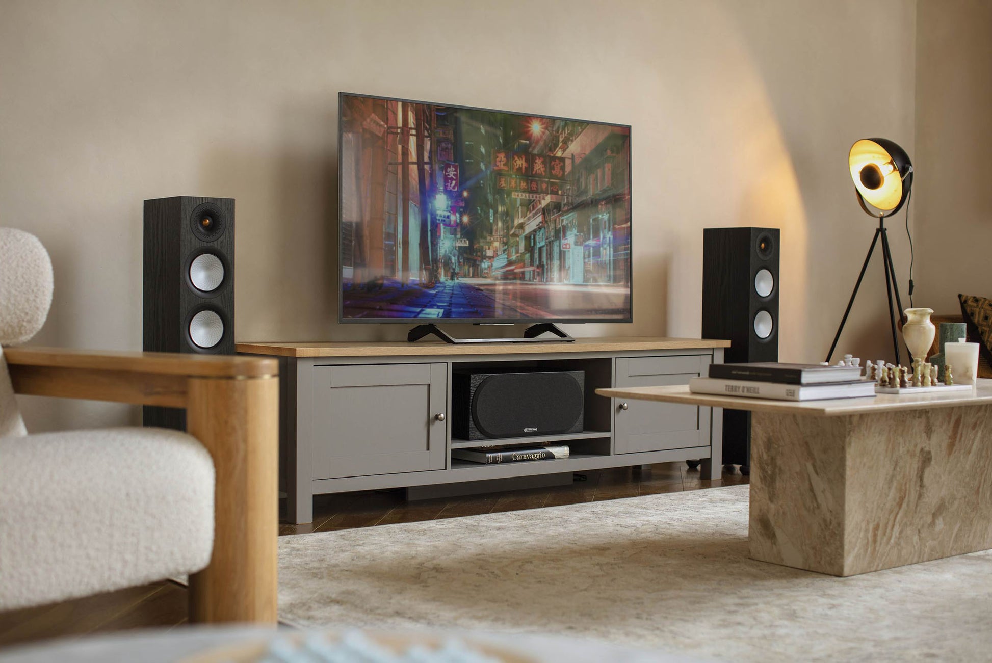 Living room setup with a TV, speakers, and decorative items.
