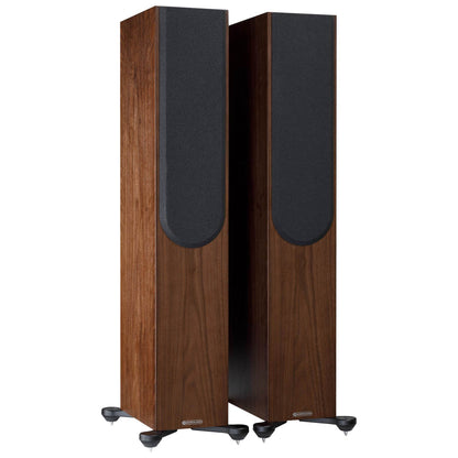 Pair of wooden speakers with black front panels on a white background