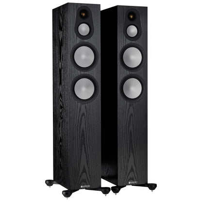 Pair of black floor-standing speakers on a white background