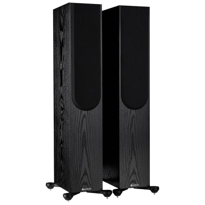 Pair of black floor-standing speakers on a white background