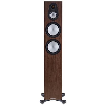 Wooden floor-standing speaker with three drivers on a white background