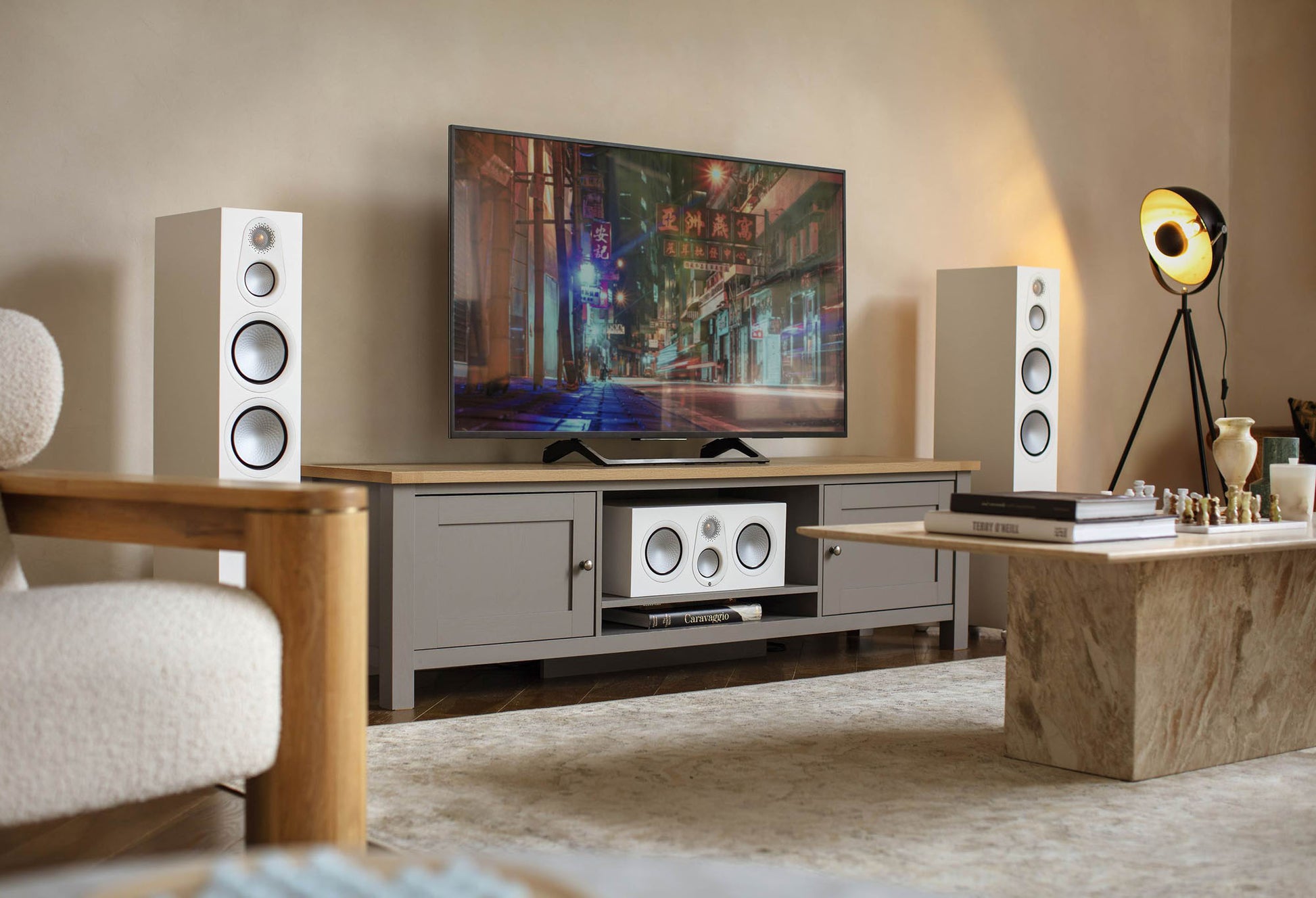 Modern living room with a television, speakers, and decorative items.