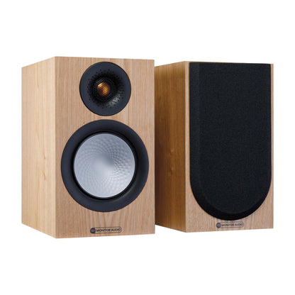 Pair of wooden speakers with black grilles on a white background
