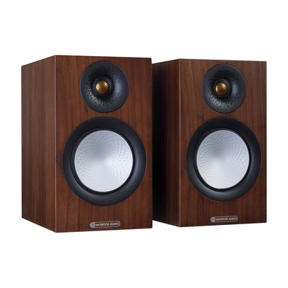 Pair of wooden speakers with black grills on a white background
