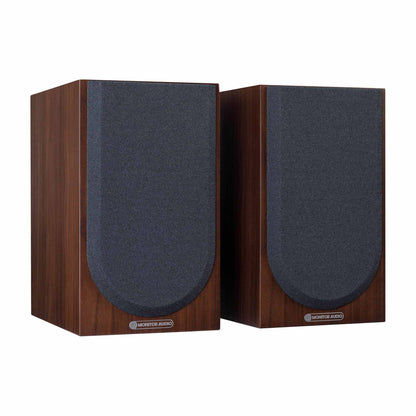 Pair of wooden speakers with grills on a white background