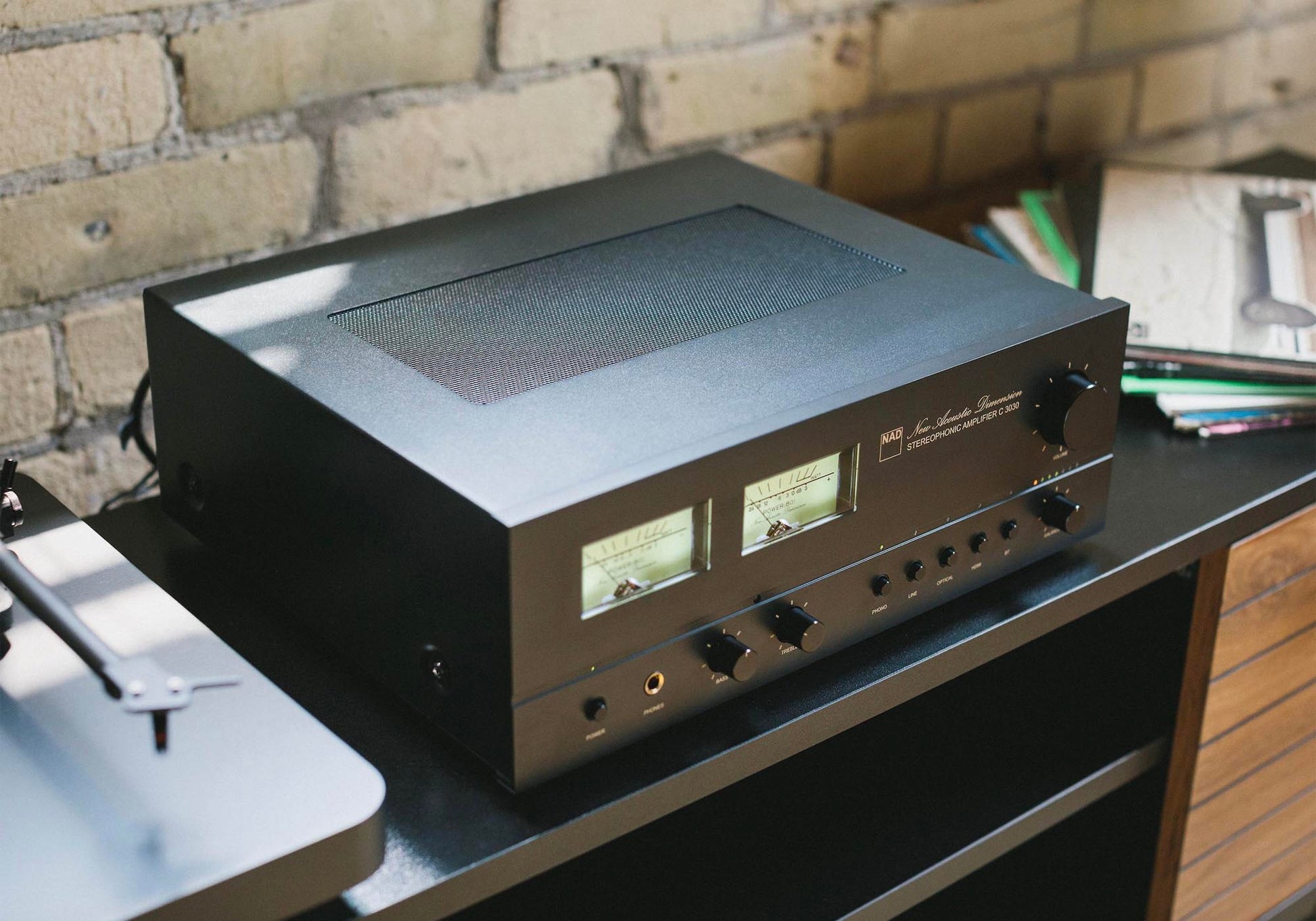 Audio amplifier on a turntable with a brick wall background