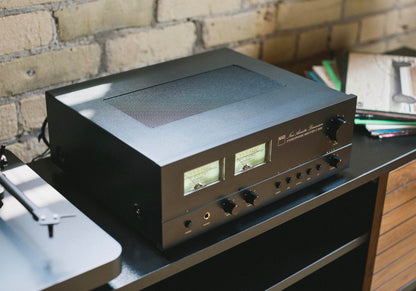 Audio amplifier on a turntable with a brick wall background