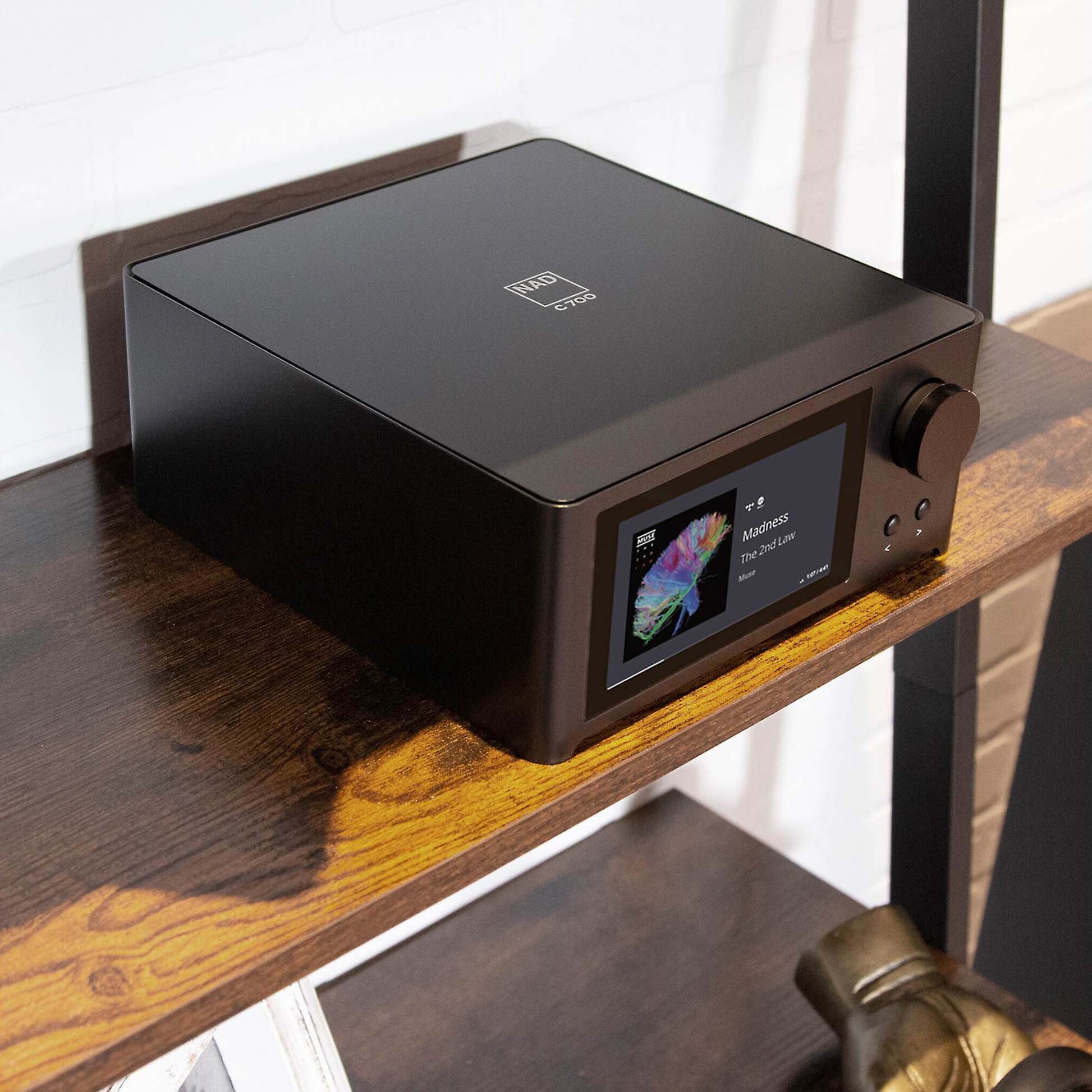 NAD C700 BluOS Streaming Amplifier setup on shelf
